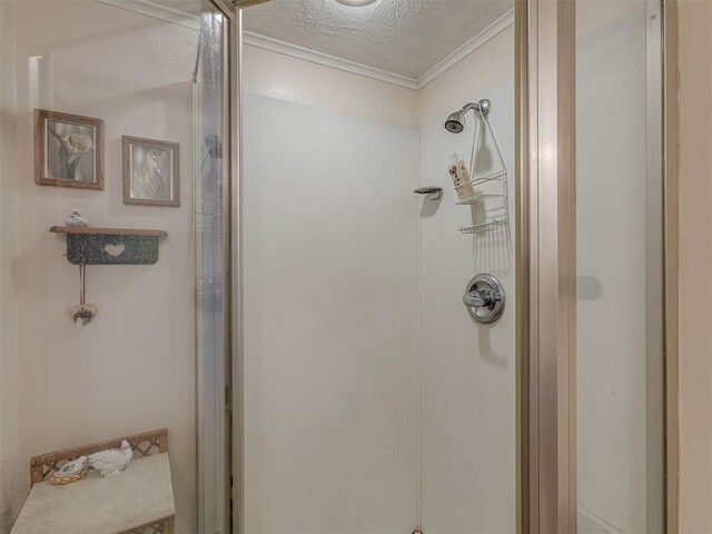 3113 SE 20th St, Oklahoma City, OK 73115 - bathroom featuring a stall shower, crown molding, and a textured ceiling
