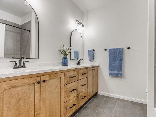 9320 NW 84th St, Yukon, OK 73099 - bathroom featuring tile patterned flooring, double vanity, and a shower