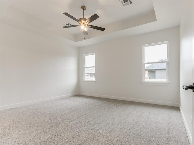 9320 NW 84th St, Yukon, OK 73099 - unfurnished room featuring a raised ceiling, light colored carpet, and a ceiling fan