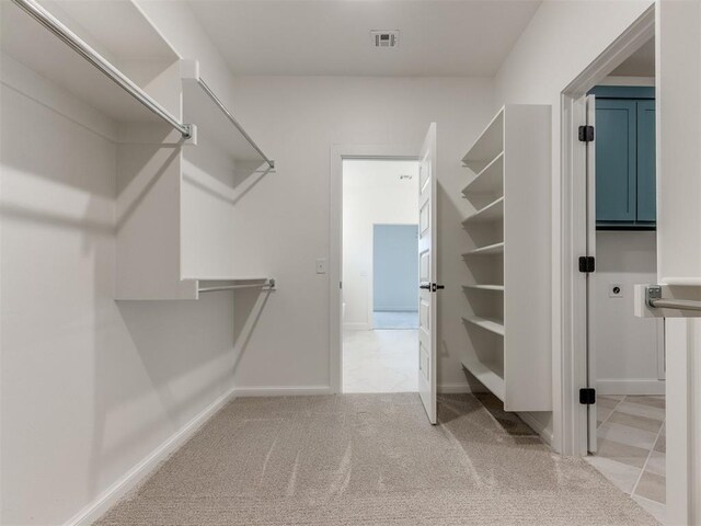 9320 NW 84th St, Yukon, OK 73099 - walk in closet featuring light colored carpet