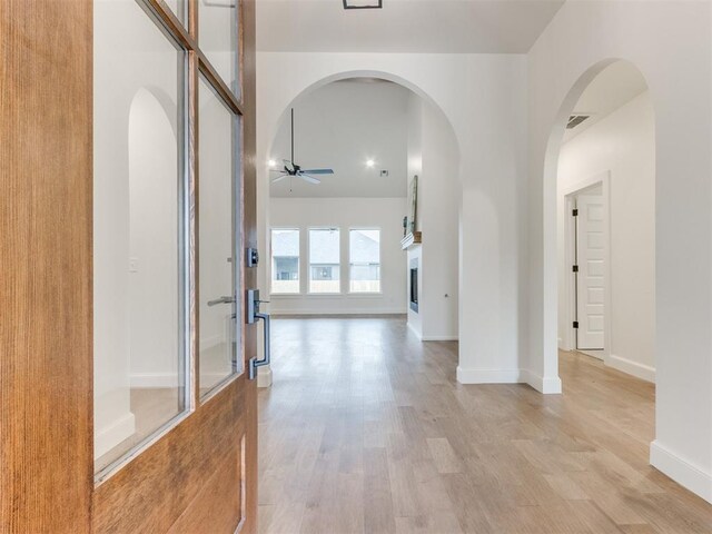 9320 NW 84th St, Yukon, OK 73099 - hallway featuring light wood finished floors and arched walkways