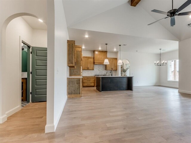 9320 NW 84th St, Yukon, OK 73099 - kitchen with a chandelier, brown cabinets, open floor plan, light countertops, and decorative backsplash