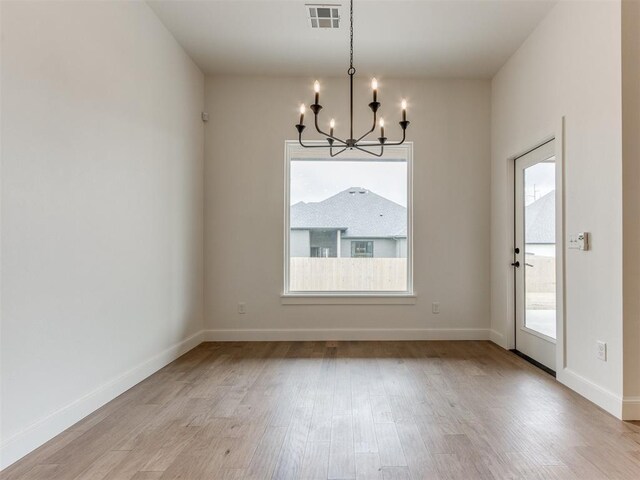 9320 NW 84th St, Yukon, OK 73099 - unfurnished dining area featuring a chandelier and light wood-type flooring