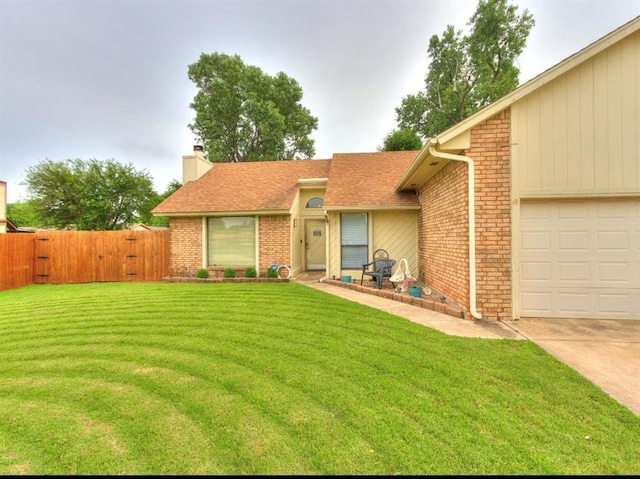 302 W Branches Way, Mustang, OK 73064 - view of front of home with brick siding, a chimney, a garage, and a gate