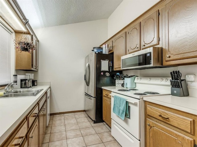302 W Branches Way, Mustang, OK 73064 - kitchen with appliances with stainless steel finishes, light countertops, a textured ceiling, and light tile patterned floors