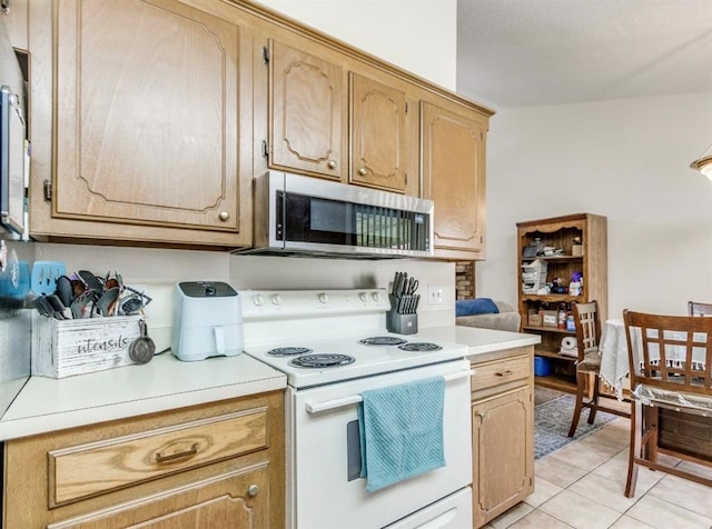 302 W Branches Way, Mustang, OK 73064 - kitchen with white electric range oven, stainless steel microwave, light countertops, and light tile patterned floors