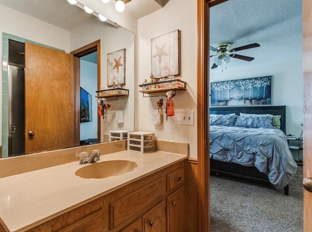 302 W Branches Way, Mustang, OK 73064 - ensuite bathroom with vanity, ceiling fan, and a textured ceiling