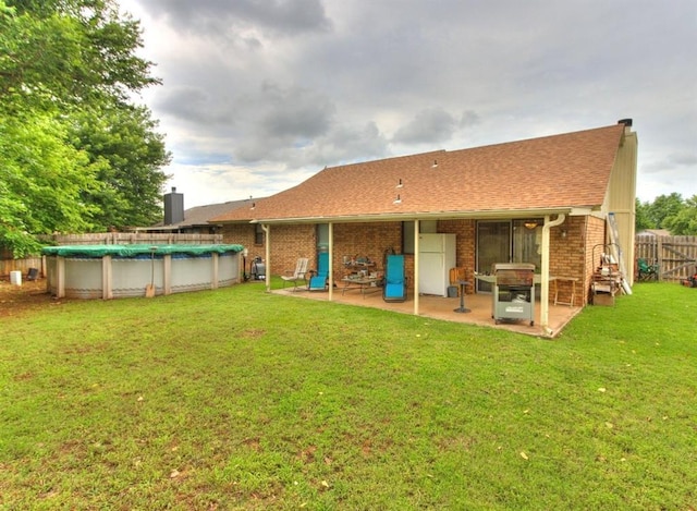 302 W Branches Way, Mustang, OK 73064 - rear view of property featuring a patio, brick siding, and roof with shingles