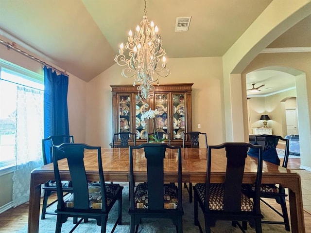 20301 Flowered Meadows Way, Edmond, OK 73012 - dining area featuring arched walkways, a chandelier, ornamental molding, ceiling fan, and lofted ceiling