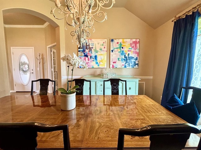 20301 Flowered Meadows Way, Edmond, OK 73012 - dining room with arched walkways, a chandelier, vaulted ceiling, and crown molding