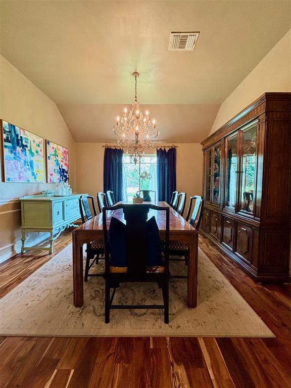 20301 Flowered Meadows Way, Edmond, OK 73012 - dining space with lofted ceiling, a chandelier, and wood finished floors