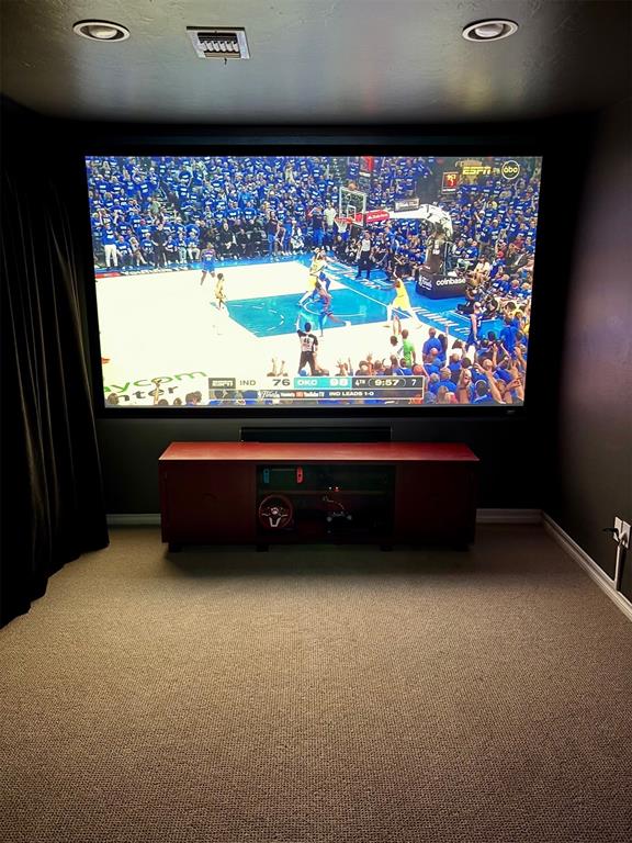 20301 Flowered Meadows Way, Edmond, OK 73012 - home theater room with light carpet and recessed lighting