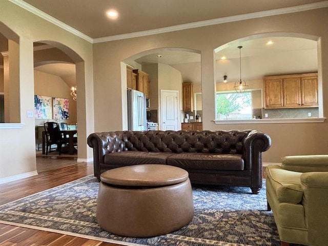 20301 Flowered Meadows Way, Edmond, OK 73012 - living room featuring dark wood-style floors, arched walkways, crown molding, and recessed lighting