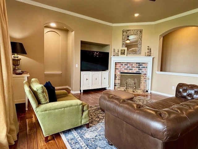 20301 Flowered Meadows Way, Edmond, OK 73012 - living room with arched walkways, wood finished floors, ornamental molding, a fireplace, and recessed lighting