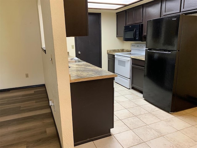 516 Ridgecrest Rd, Edmond, OK 73013 - kitchen featuring black appliances, light tile patterned floors, light countertops, and dark brown cabinets