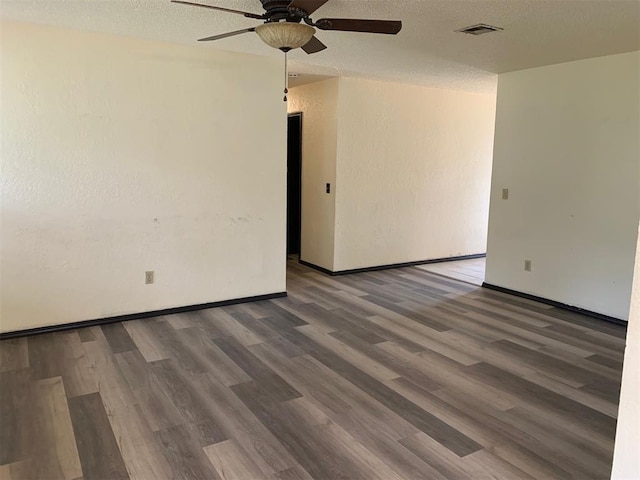 516 Ridgecrest Rd, Edmond, OK 73013 - empty room with ceiling fan, wood finished floors, a textured ceiling, and a textured wall