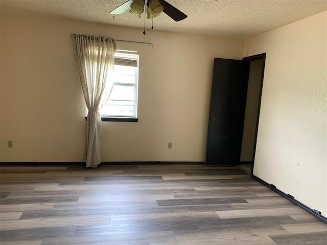 516 Ridgecrest Rd, Edmond, OK 73013 - spare room with ceiling fan, a textured ceiling, and wood finished floors