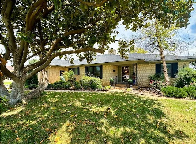 1516 N Hudson St, Altus, OK 73521 - single story home featuring brick siding, a front lawn, and a chimney