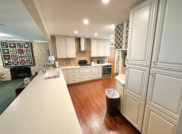 1516 N Hudson St, Altus, OK 73521 - kitchen with wall chimney exhaust hood, appliances with stainless steel finishes, backsplash, light countertops, and light wood-type flooring