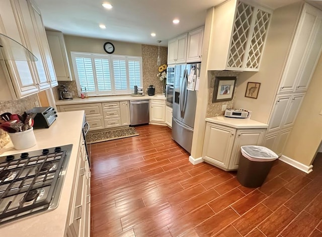 1516 N Hudson St, Altus, OK 73521 - kitchen with appliances with stainless steel finishes, dark wood-style floors, decorative backsplash, light countertops, and recessed lighting