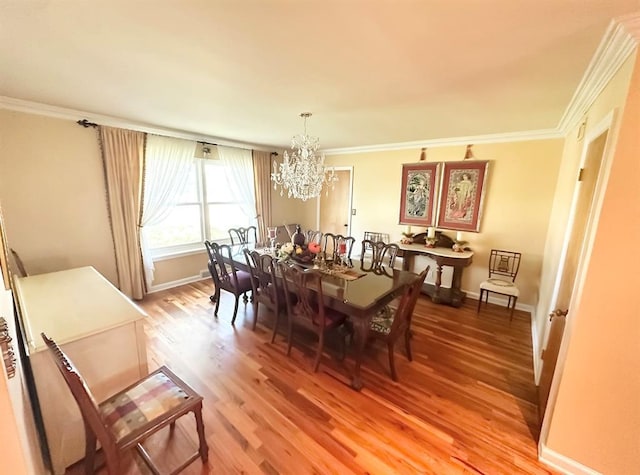 1516 N Hudson St, Altus, OK 73521 - dining space featuring a chandelier, light wood-style flooring, and crown molding