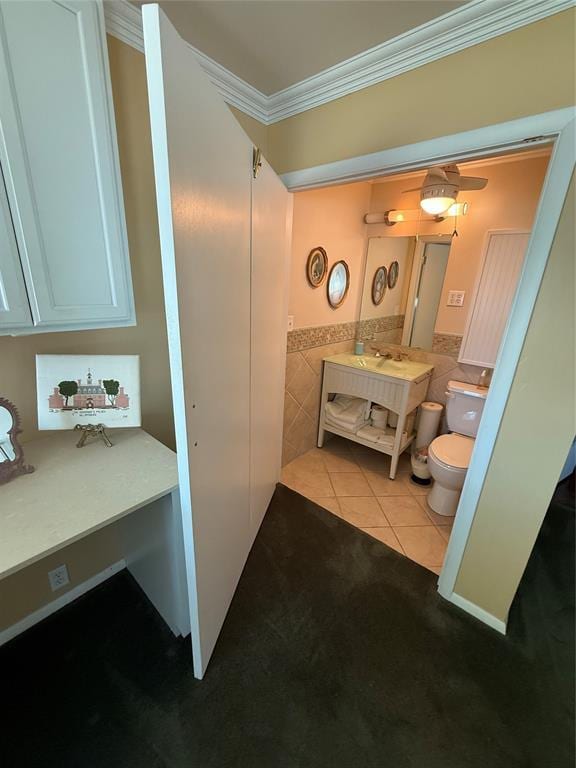 1516 N Hudson St, Altus, OK 73521 - bathroom with ornamental molding, tile patterned flooring, vanity, tile walls, and wainscoting