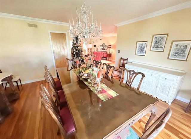 1516 N Hudson St, Altus, OK 73521 - dining space with a chandelier, crown molding, and wood finished floors