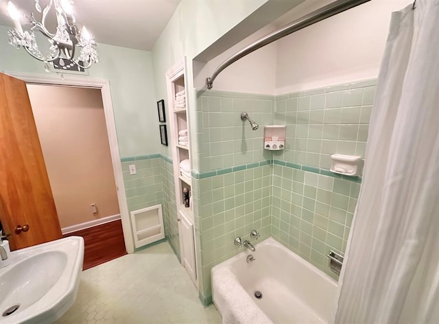 1516 N Hudson St, Altus, OK 73521 - full bathroom featuring shower / bath combination with curtain, tile walls, a chandelier, and wainscoting