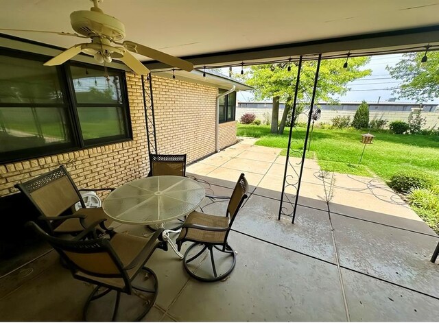 1516 N Hudson St, Altus, OK 73521 - fenced backyard with ceiling fan, a patio, and outdoor dining space