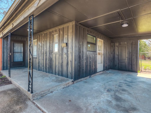 2104 Westchester Dr, Oklahoma City, OK 73120 - doorway to property featuring board and batten siding and covered porch