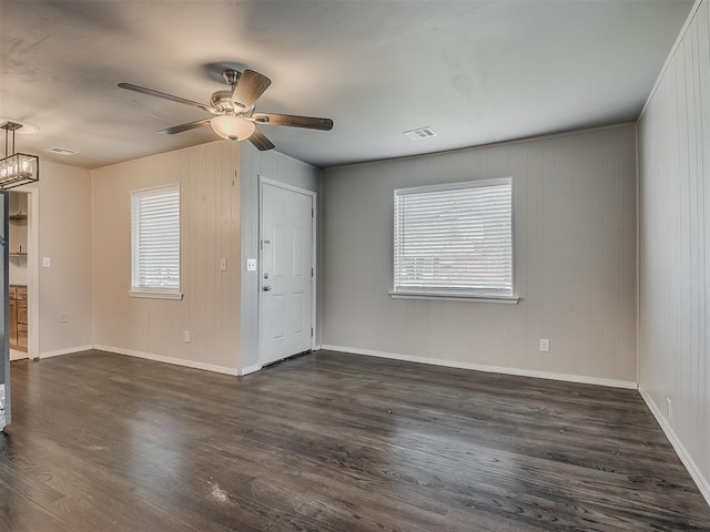 2104 Westchester Dr, Oklahoma City, OK 73120 - empty room with dark wood-style floors, plenty of natural light, and a ceiling fan