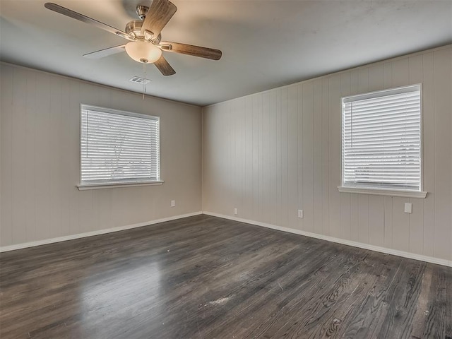 2104 Westchester Dr, Oklahoma City, OK 73120 - empty room featuring dark wood-type flooring, a ceiling fan, and plenty of natural light