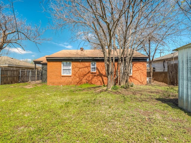 2104 Westchester Dr, Oklahoma City, OK 73120 - back of house featuring brick siding and a fenced backyard
