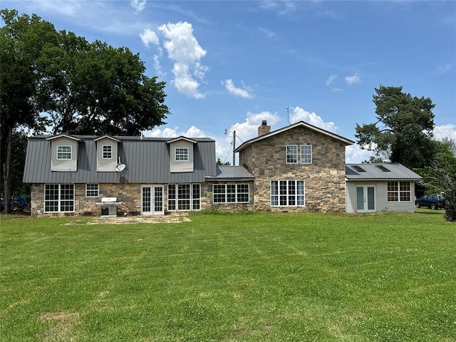 36166 Ew 1120th Rd, Seminole, OK 74868 - rear view of house with french doors, stone siding, a metal roof, a chimney, and a yard