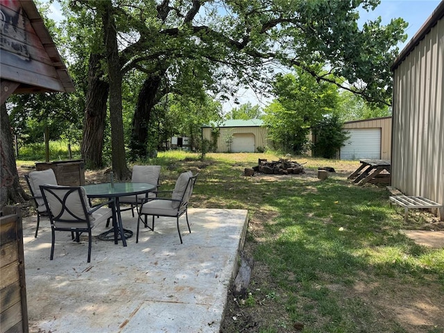 36166 Ew 1120th Rd, Seminole, OK 74868 - view of green lawn featuring outdoor dining area, a patio, and an outbuilding