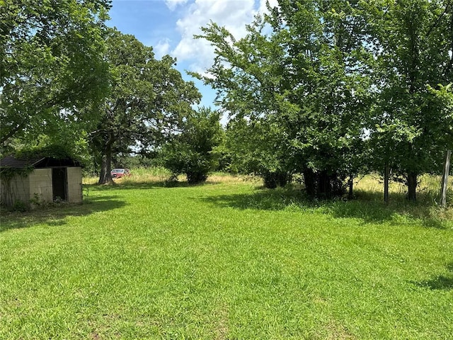 36166 Ew 1120th Rd, Seminole, OK 74868 - view of green lawn featuring a storage shed