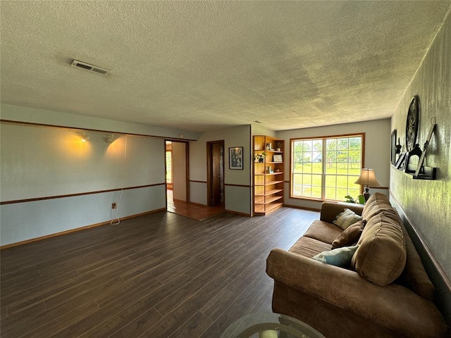 36166 Ew 1120th Rd, Seminole, OK 74868 - living area featuring a textured ceiling and dark wood-style flooring