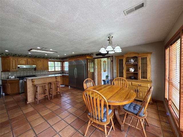 36166 Ew 1120th Rd, Seminole, OK 74868 - dining space with a textured ceiling, a chandelier, tile patterned flooring, and recessed lighting