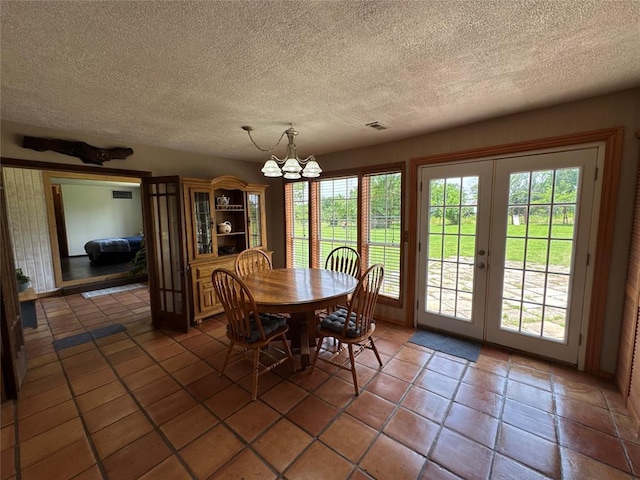 36166 Ew 1120th Rd, Seminole, OK 74868 - dining space with french doors, a chandelier, a textured ceiling, and tile patterned floors