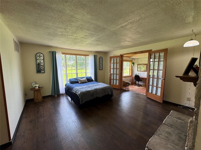 36166 Ew 1120th Rd, Seminole, OK 74868 - bedroom with french doors, a textured ceiling, and wood finished floors