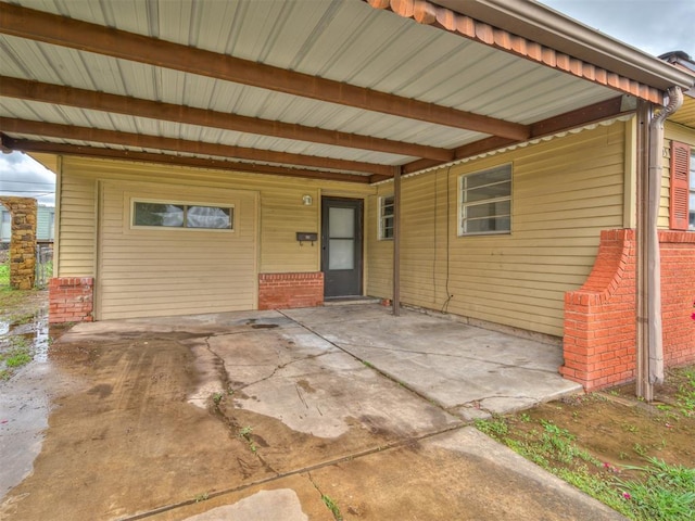 2805 SW 60th St, Oklahoma City, OK 73159 - doorway to property with a carport and brick siding