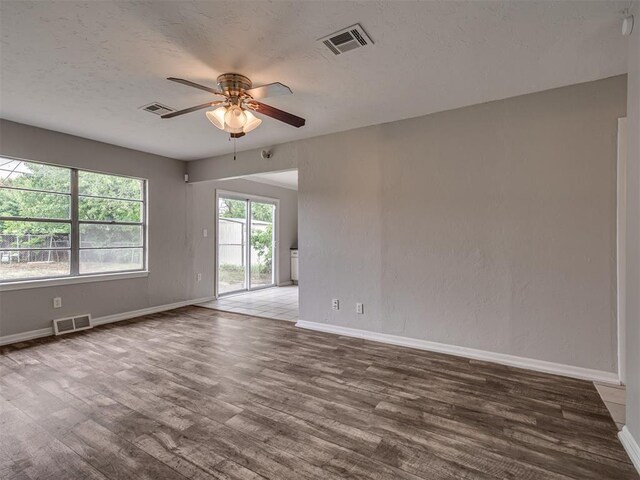 2805 SW 60th St, Oklahoma City, OK 73159 - empty room featuring ceiling fan, wood finished floors, and a textured ceiling