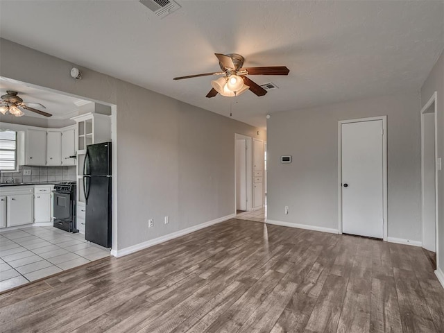2805 SW 60th St, Oklahoma City, OK 73159 - unfurnished living room with ceiling fan and light wood-style floors