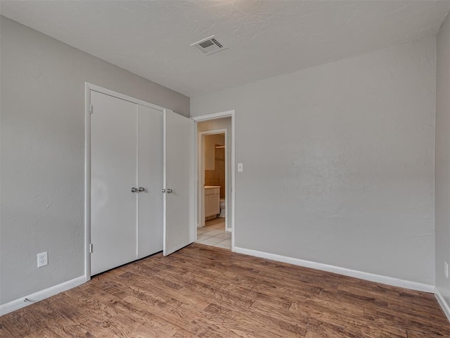 2805 SW 60th St, Oklahoma City, OK 73159 - unfurnished bedroom featuring light wood-type flooring and a closet