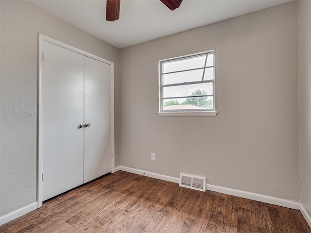 2805 SW 60th St, Oklahoma City, OK 73159 - unfurnished bedroom with a closet, wood finished floors, and ceiling fan