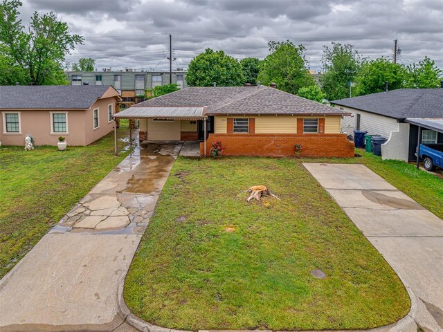 2805 SW 60th St, Oklahoma City, OK 73159 - view of front of house with concrete driveway, brick siding, a front lawn, and a shingled roof