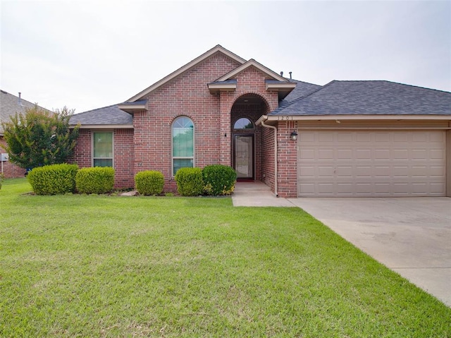 1201 W Churchill Way, Mustang, OK 73064 - view of front facade featuring a shingled roof, brick siding, an attached garage, and driveway