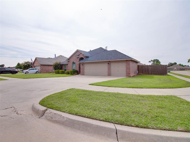 1201 W Churchill Way, Mustang, OK 73064 - view of front of house with brick siding, concrete driveway, a garage, and roof with shingles