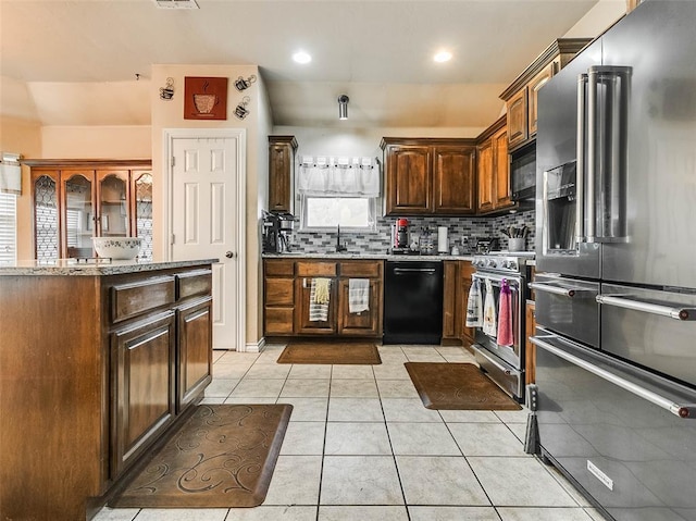 1201 W Churchill Way, Mustang, OK 73064 - kitchen featuring black appliances, tasteful backsplash, light stone countertops, light tile patterned flooring, and dark brown cabinets