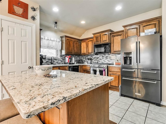 1201 W Churchill Way, Mustang, OK 73064 - kitchen with black appliances, decorative backsplash, light tile patterned floors, light stone counters, and vaulted ceiling